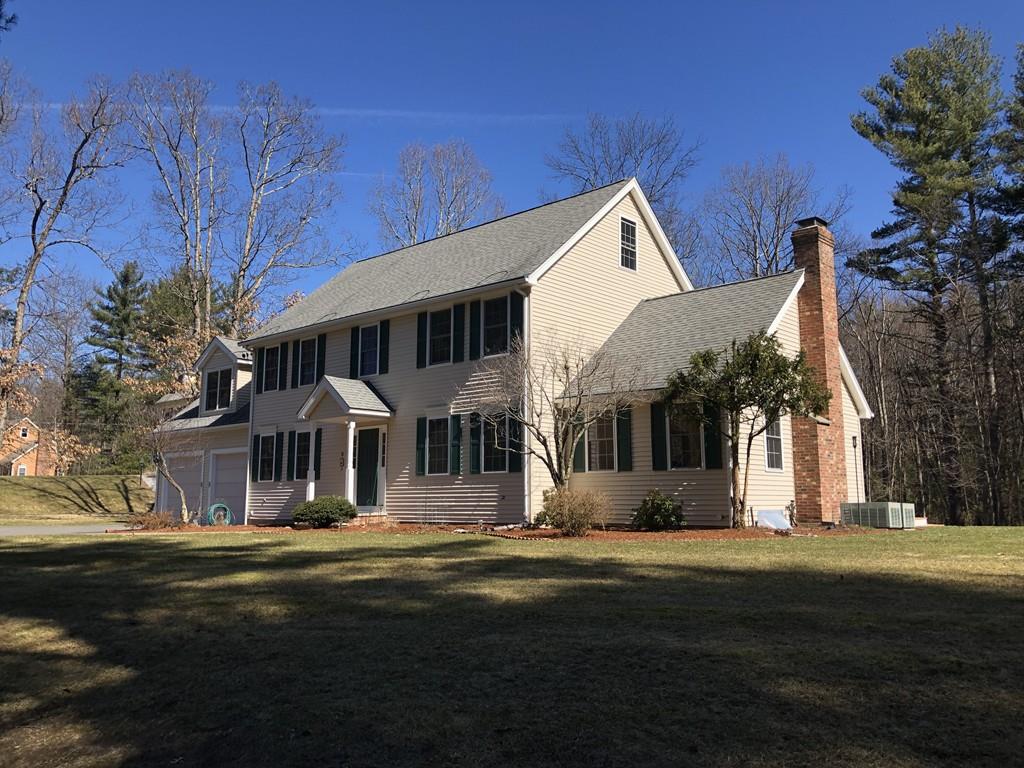 18 Cow Pond Brook Road Groton, MA 01450 - Photo 2 of 40 a front view of a house with a garden