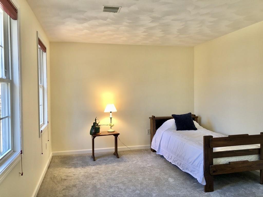 18 Cow Pond Brook Road Groton, MA 01450 - Photo 30 of 40 a bedroom with a bed and a window