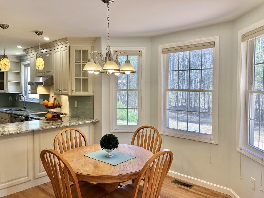 18 Cow Pond Brook Road Groton, MA 01450 - Photo 8 of 40 a dining room with furniture a chandelier and window
