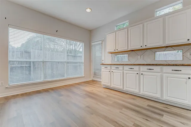 a view of a kitchen with granite countertop cabinets and a wooden floor