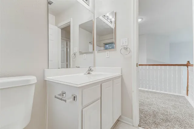 a bathroom with a sink a toilet a mirror and shower