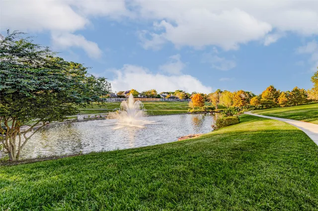 a view of a lake with houses in the back