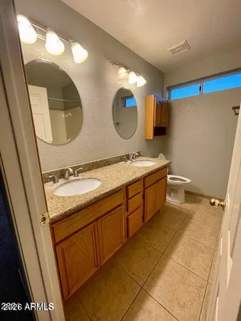 a bathroom with a double vanity sink and mirror