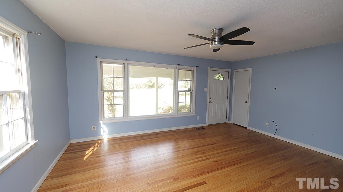 617 Locust Lane Raleigh, NC 27603 - Photo 2 of 15 a view of empty room with wooden floor and fan