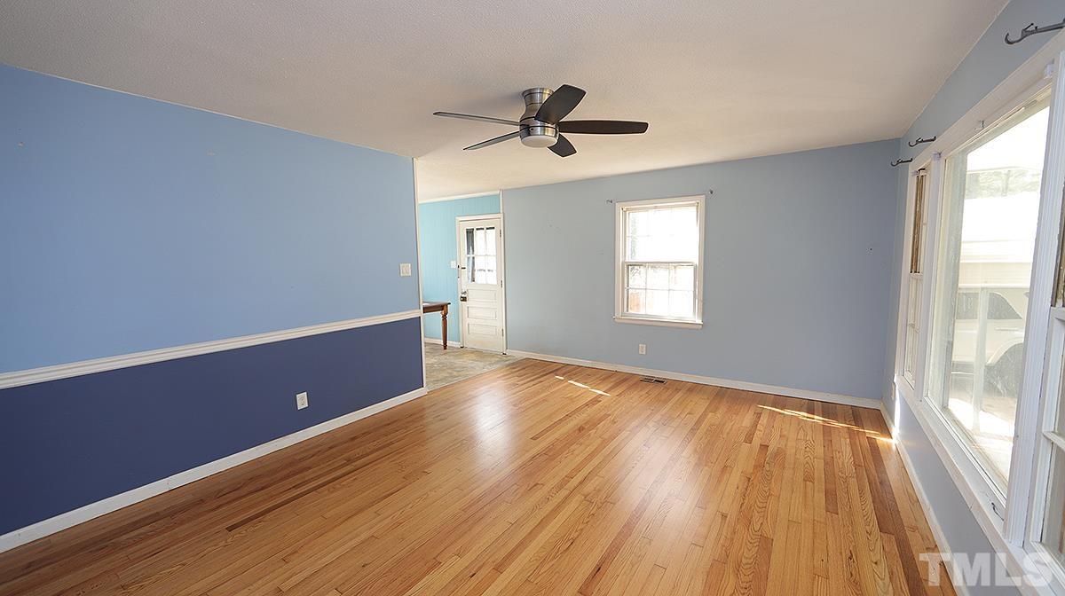 617 Locust Lane Raleigh, NC 27603 - Photo 3 of 15 a view of empty room with wooden floor and fan