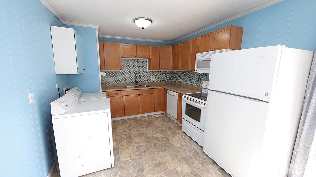 617 Locust Lane Raleigh, NC 27603 - Photo 5 of 15 a kitchen with a sink a stove and refrigerator