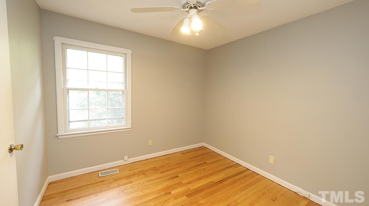 617 Locust Lane Raleigh, NC 27603 - Photo 9 of 15 wooden floor in an empty room with a window