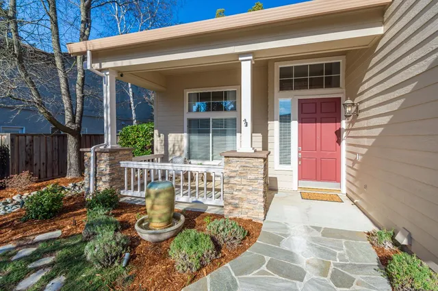a view of a chair and table in backyard of the house
