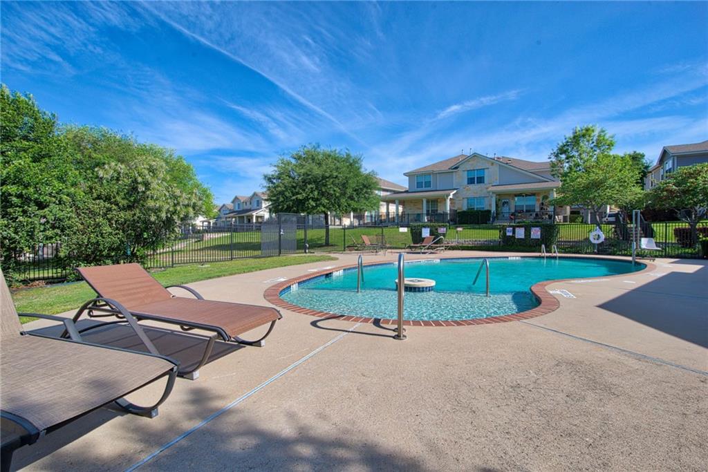 1900 Scofield Ridge Parkway, Unit 5501 Austin, TX 78727 - Photo 16 of 21 A refreshing pool awaits on a clear day, nestled within a charming residential community.