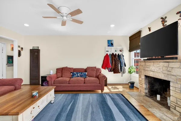 a living room with furniture fireplace and flat screen tv