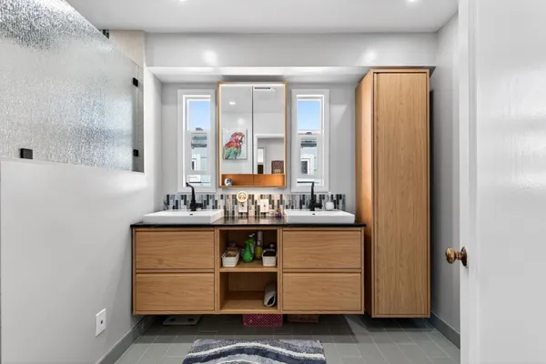 a bathroom with a sink a mirror and shower