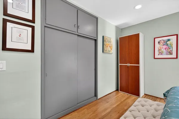 a view of a porch with furniture and wooden floor