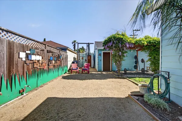 a view of a backyard with wooden fence