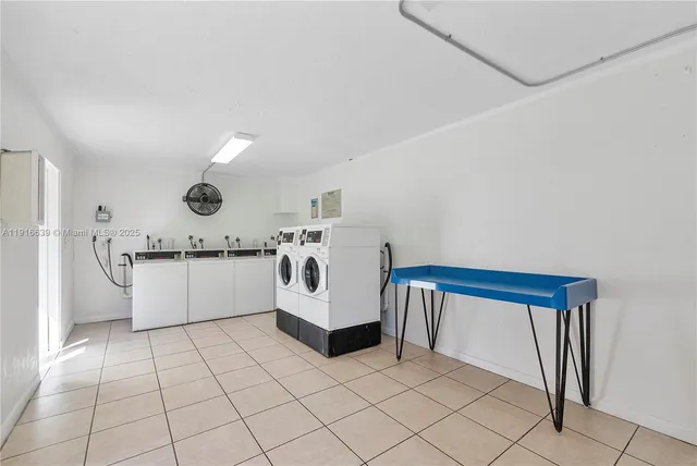a view of kitchen with cabinets and window