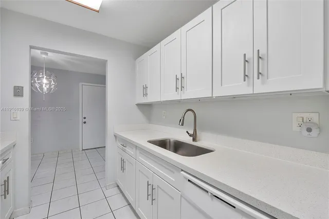 a kitchen with a sink and cabinets