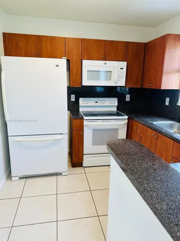 a kitchen with a stove and a refrigerator