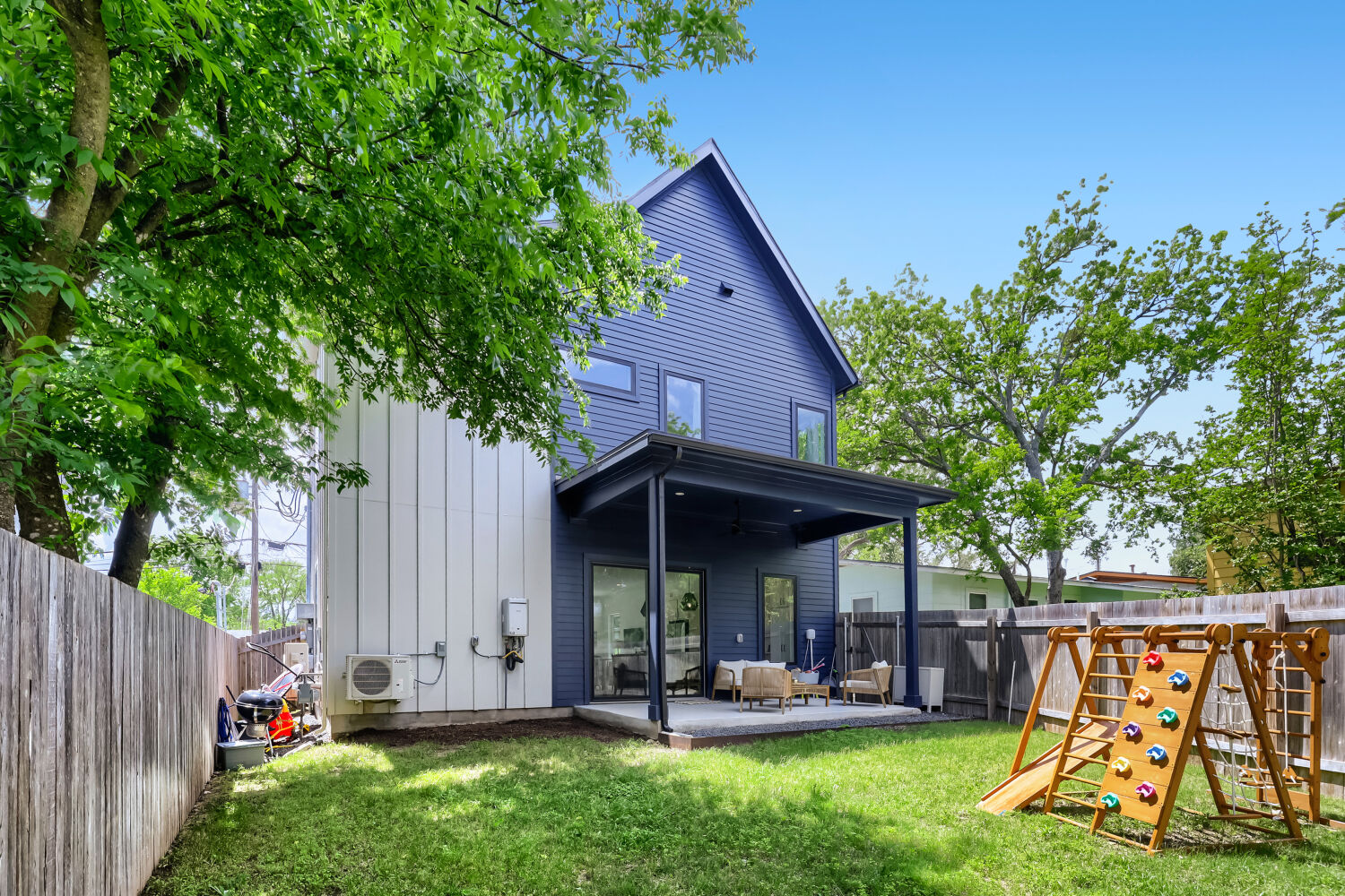 4804 Ribbecke Avenue, Unit A Austin, TX 78721 - Photo 26 of 32 The property features a spacious backyard with a lawn and mature trees, a covered patio, and a privacy fence