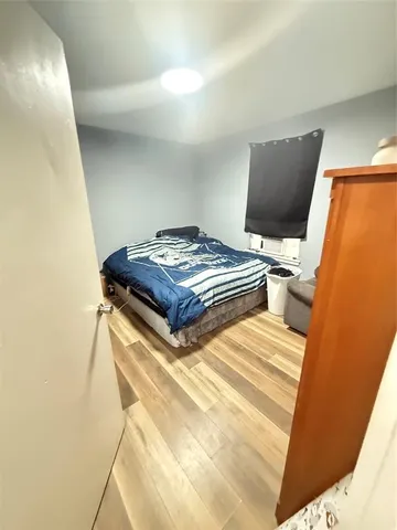 a bedroom with a bed and flat screen tv