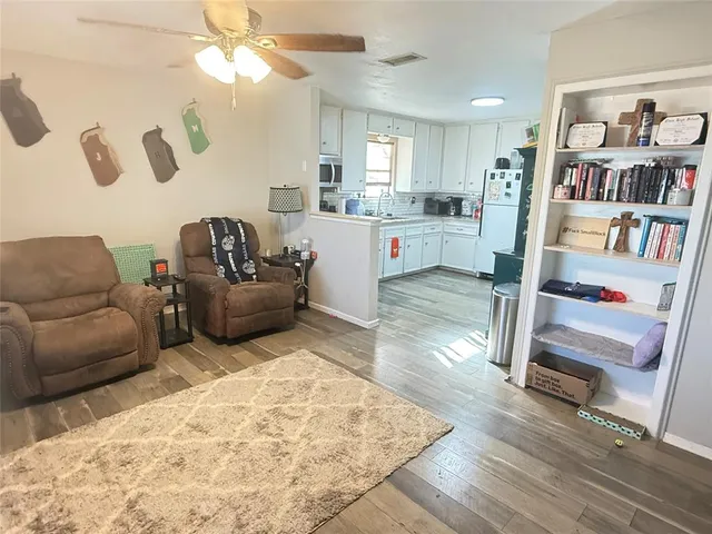 a living room with furniture and a book shelf