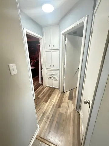 a view of a kitchen with refrigerator and white cabinets
