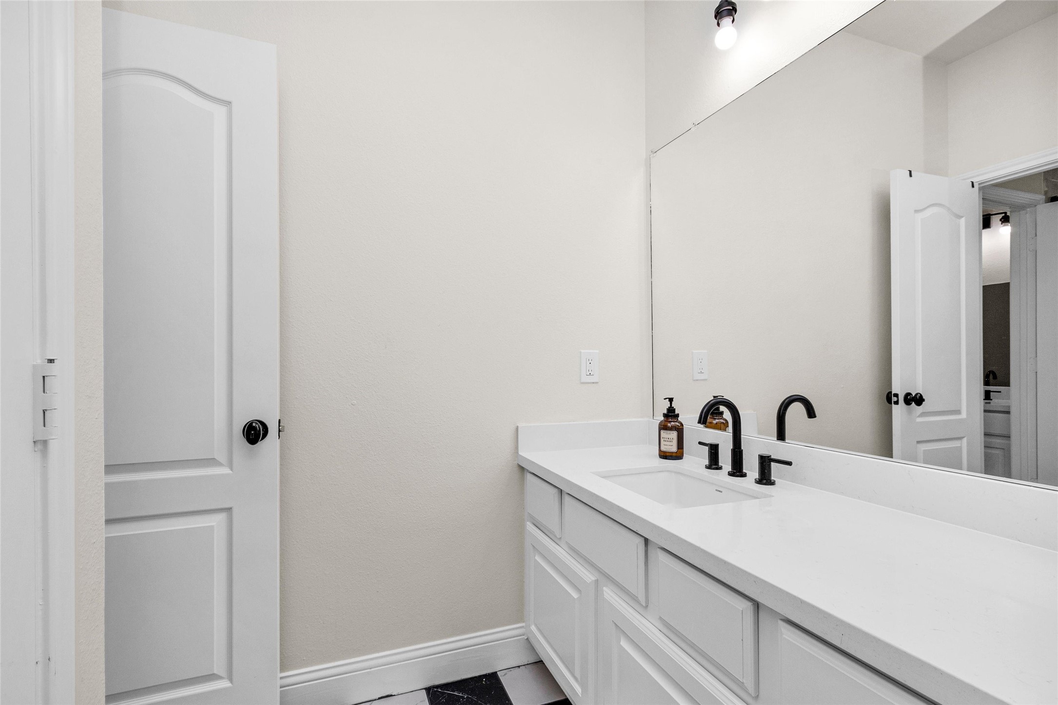 10004 Summer Ridge Lane Conroe, TX 77302 - Photo 39 of 50 a bathroom with a sink and mirror