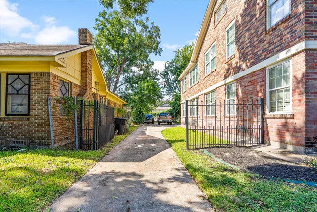a view of a house with a backyard and a small cabin