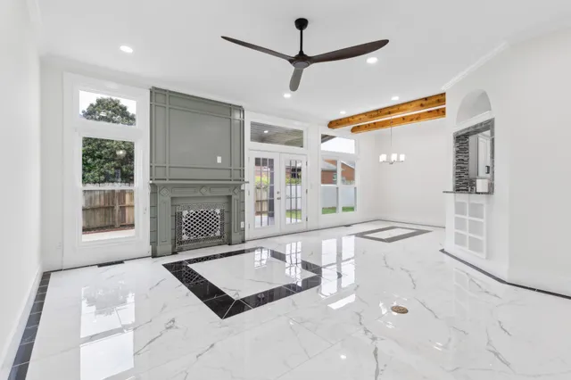 a living room with furniture a flat screen tv and a large window