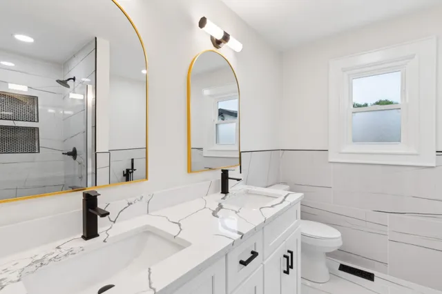 a bathroom with a double vanity sink and a mirror