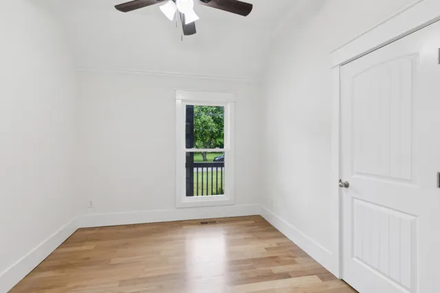 wooden floor in an empty room with a window