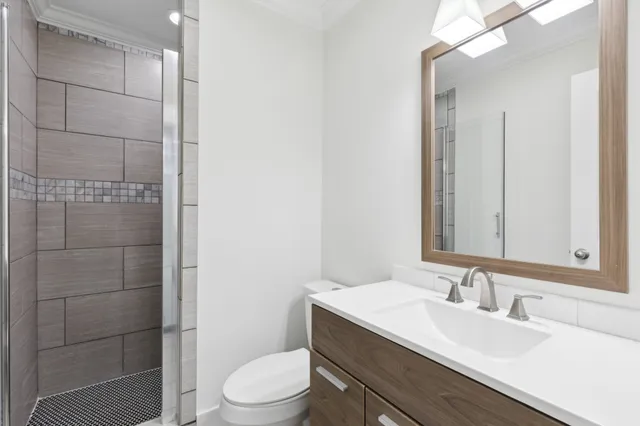 a bathroom with a sink a toilet and shower