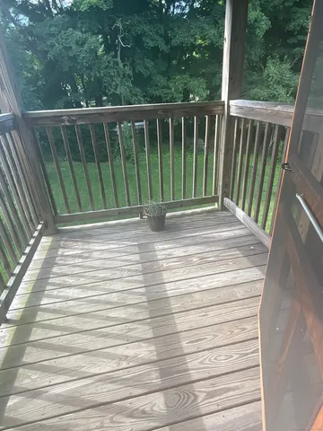 a view of a balcony with wooden floor