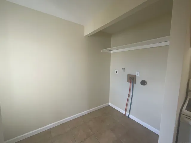 a view of a hallway to a livingroom with furniture