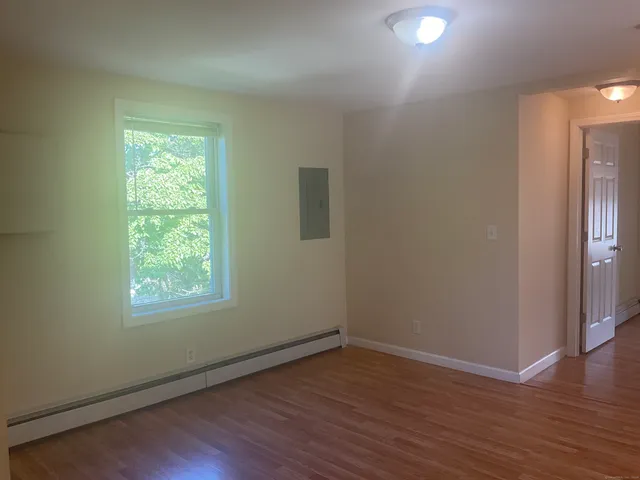wooden floor in an empty room with a window