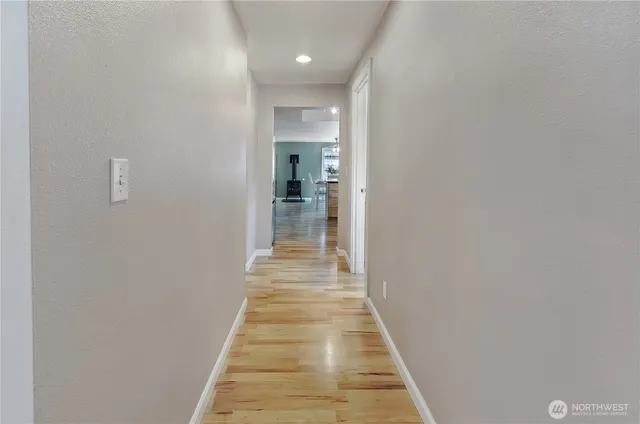 a view of a hallway with wooden floor
