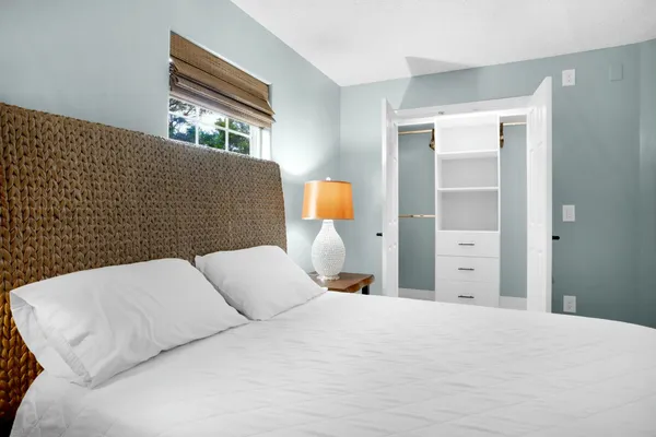 a bathroom with a granite countertop sink a toilet and a mirror