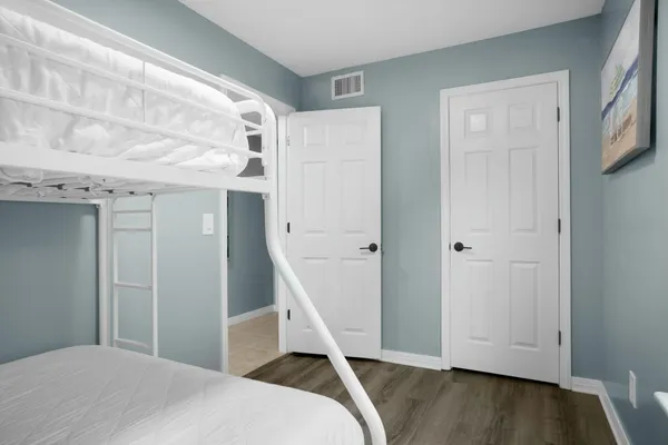 a view of a patio with a table and chairs under an umbrella