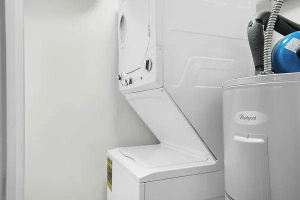 a living room with furniture a chandelier and a fireplace