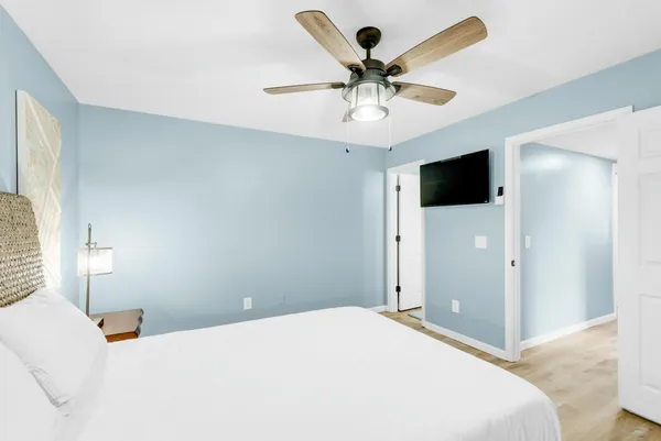a kitchen with granite countertop white cabinets and stainless steel appliances