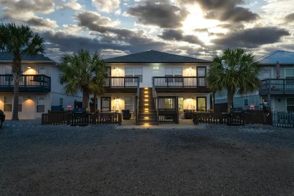 a bedroom with a large bed and ceiling fan