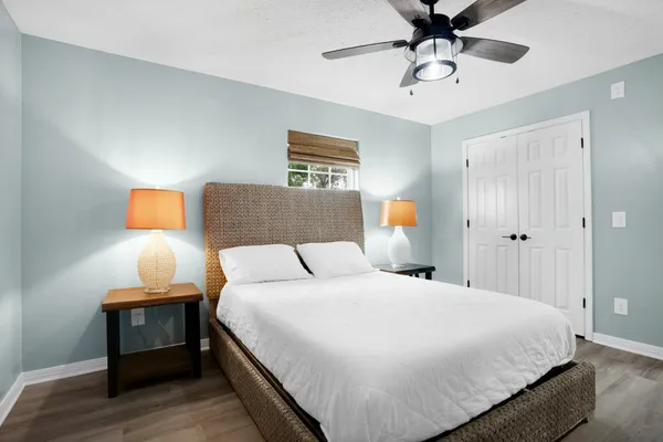 a bedroom with a bed and a flat tv screen next to a window
