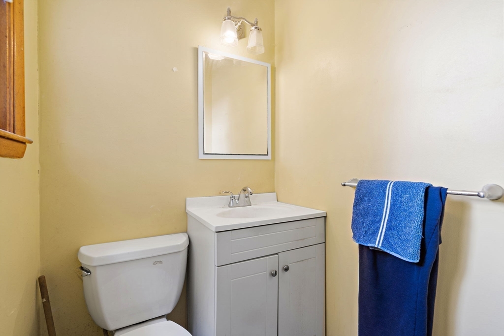 30 Rolling Lane Sudbury, MA 01776 - Photo 15 of 25 a bathroom with a toilet sink vanity and mirror