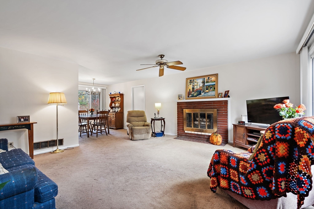 30 Rolling Lane Sudbury, MA 01776 - Photo 4 of 25 a living room with furniture a fireplace and a flat screen tv