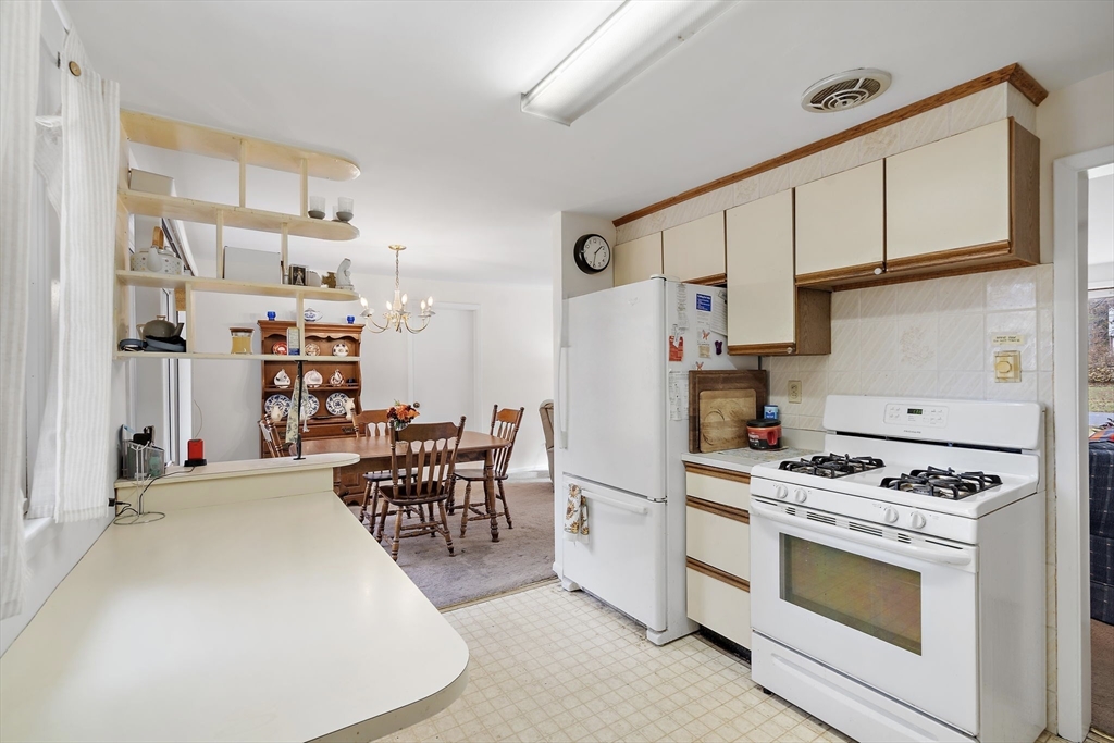 30 Rolling Lane Sudbury, MA 01776 - Photo 7 of 25 a kitchen with stainless steel appliances a stove a sink and cabinets