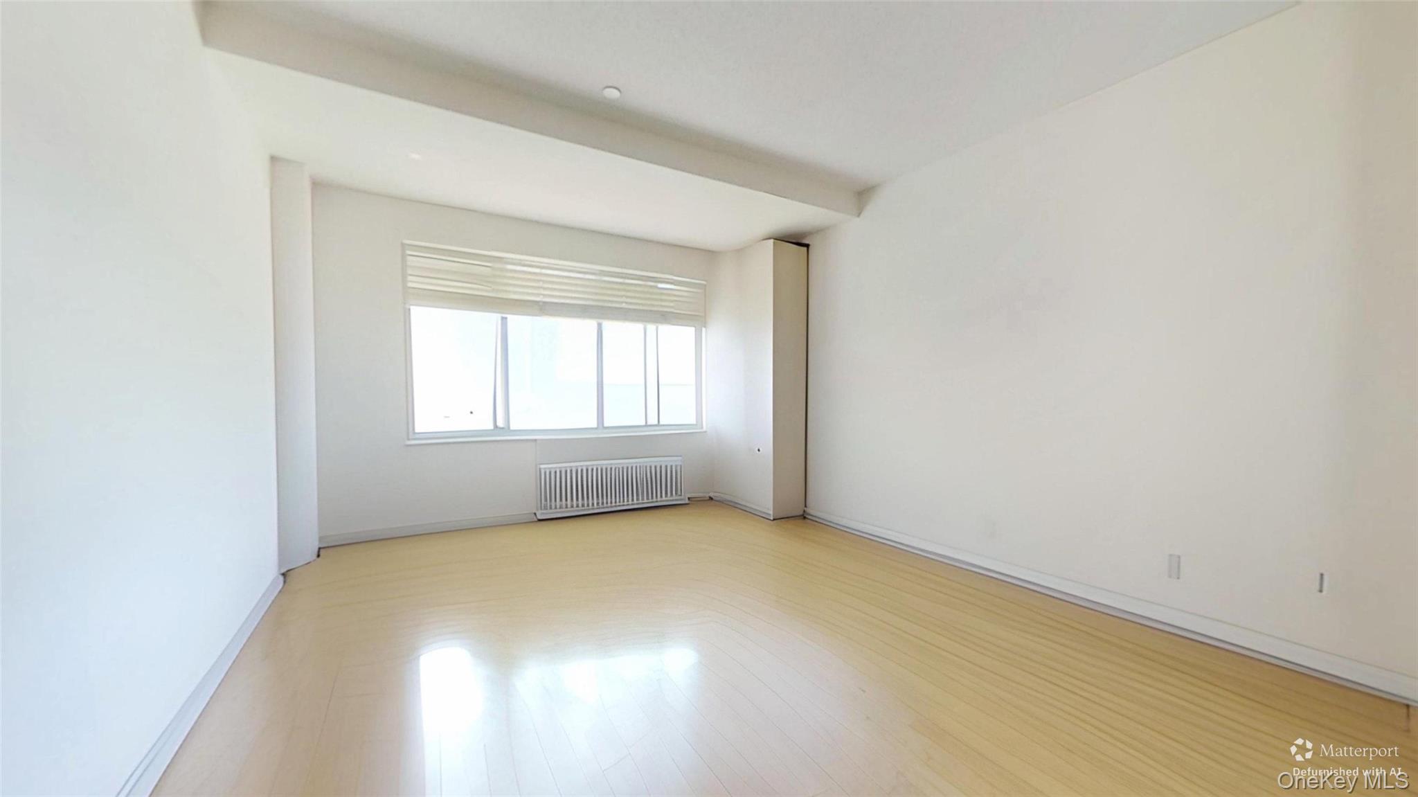 116-12 Ocean Promenade, Unit 210 Queens, NY 11694 - Photo 12 of 28 Unfurnished room featuring radiator and wood finished floors