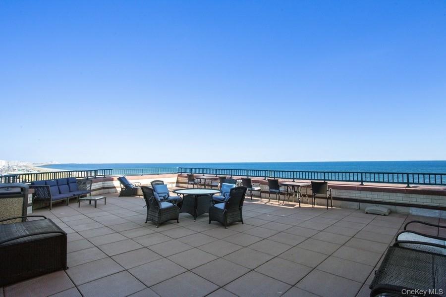 116-12 Ocean Promenade, Unit 210 Queens, NY 11694 - Photo 2 of 28 View of patio with a water view and outdoor dining area