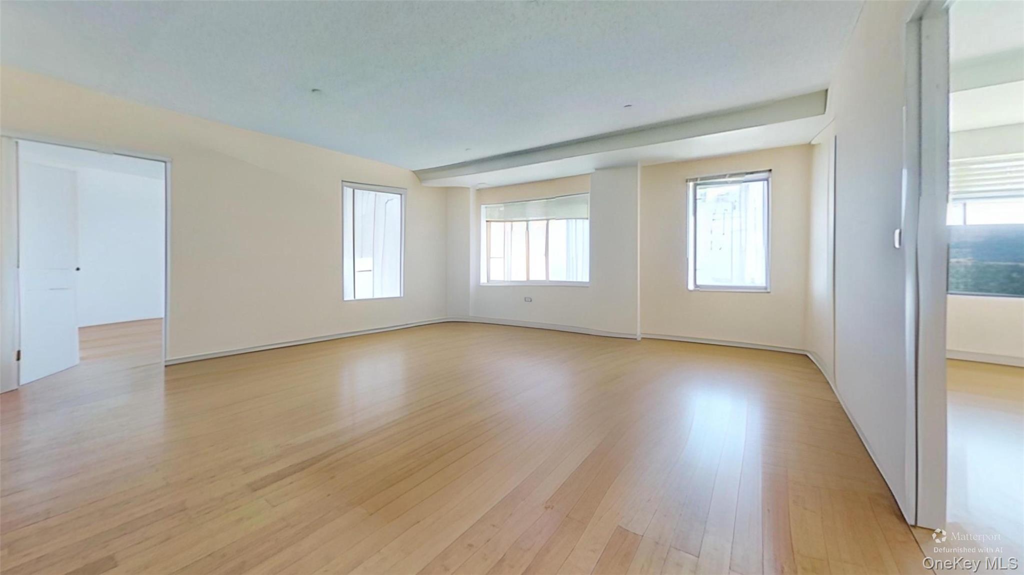 116-12 Ocean Promenade, Unit 210 Queens, NY 11694 - Photo 3 of 28 Unfurnished room featuring light wood-style flooring