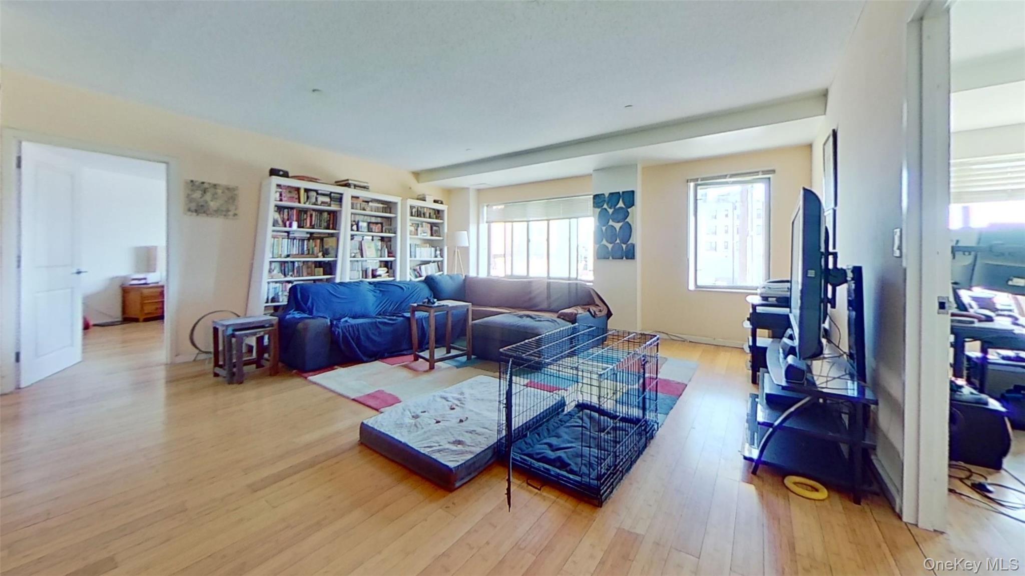 116-12 Ocean Promenade, Unit 210 Queens, NY 11694 - Photo 4 of 28 Living area featuring light wood-style flooring and healthy amount of natural light