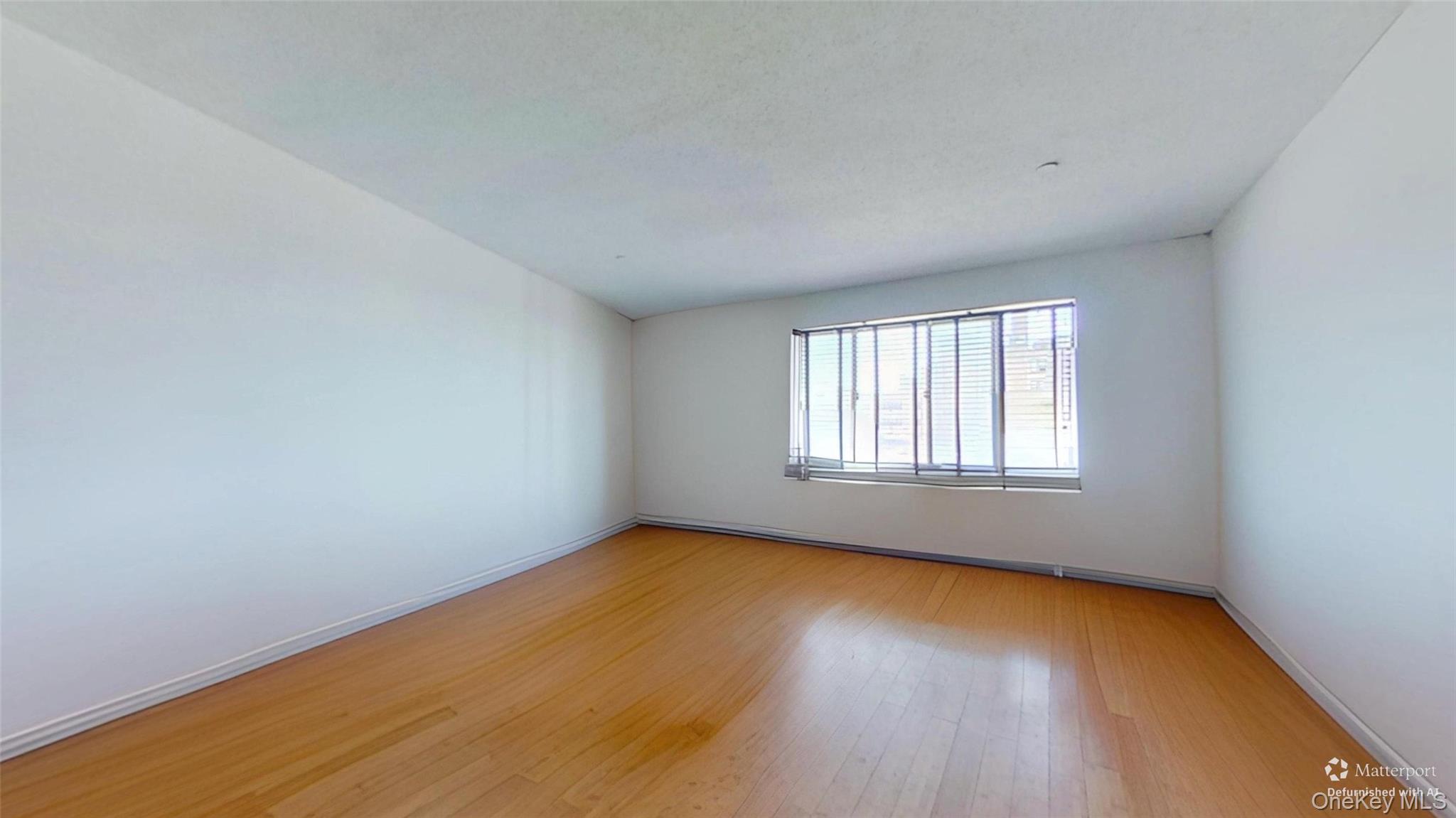 116-12 Ocean Promenade, Unit 210 Queens, NY 11694 - Photo 8 of 28 Empty room with light wood-type flooring