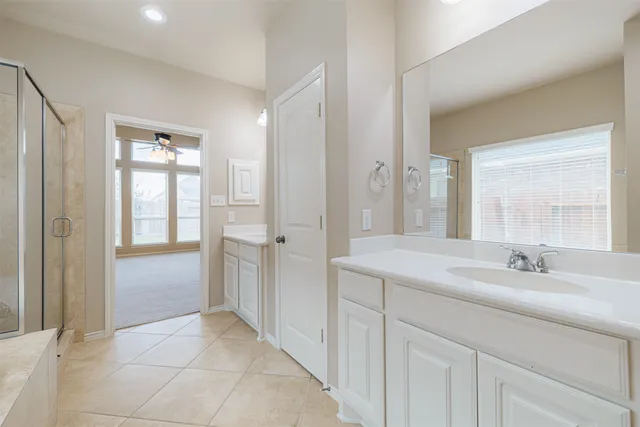 a spacious bathroom with a double vanity sink mirror and