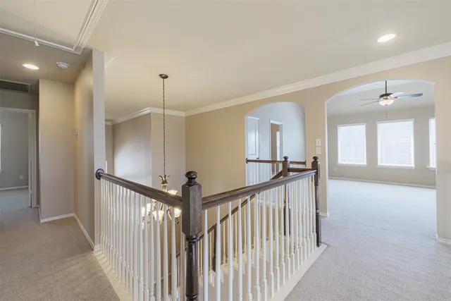 a view of a hallway with windows and stairs